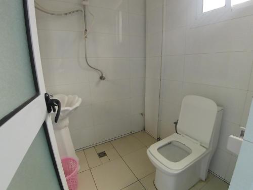 a small bathroom with a toilet and a sink at Jacobs Hôtel in Douala