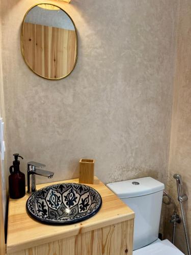 a bathroom with a sink and a mirror on a counter at SURFHALLA Morocco in Imsouane