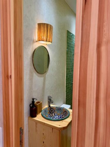 a bathroom with a sink and a mirror at SURFHALLA Morocco in Imsouane