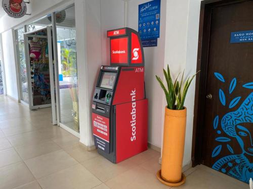 a ticket redemption machine in a building with a vase at Hotel Santa Cruz Huatulco in Santa Cruz Huatulco