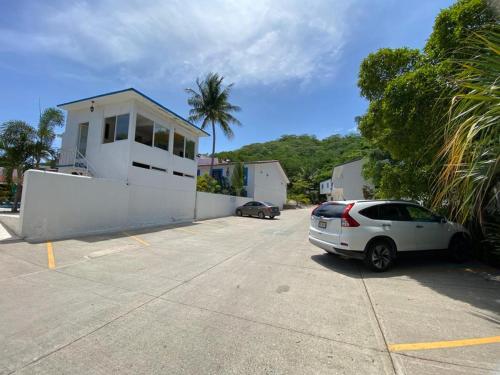 a car parked in a parking lot next to a house at Hotel Santa Cruz Huatulco in Santa Cruz Huatulco