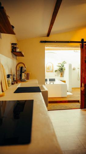 a kitchen with a counter and a large window at Love room Piccola casa, côté île in La Verpillière