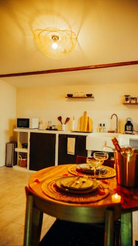 a kitchen with a table with a counter top at Love room Piccola casa, côté île in La Verpillière