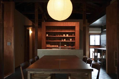 a dining room with a table and a light fixture at suo Camellia Island Inn - Vacation STAY 95452v in Oshima
