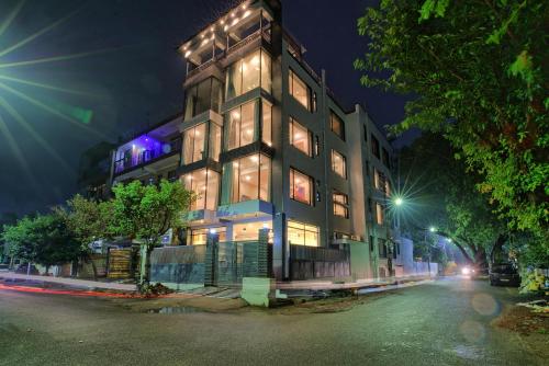 a tall building is lit up at night at Aarchh Regency Noida in Noida