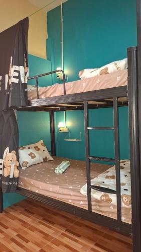 two bunk beds in a room with a bed at So Cute Hostel, Kai Bae, Koh Chang in Trat