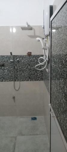 a bathroom with a shower with a glass door at Villa 307A in Matara