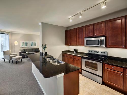 a kitchen with wooden cabinets and a counter top at AVE Union - Furnished Apartment, Union NJ in Union