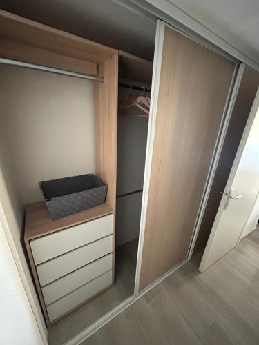 a walk in closet with a door and a drawer at Le port du brusc chambre chez l habitant in Six-Fours-les-Plages