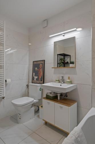 a bathroom with a sink and a toilet and a mirror at Greenplace in Bucharest