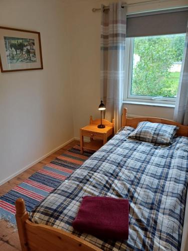 a bedroom with a large bed and a window at Centrally located holiday home in Stöllet in Stöllet