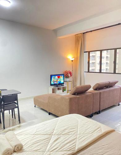 a bedroom with two beds and a table and a television at Studio with Rooftop Pool at Youth City Nilai by D'KAY HOMES, near USIM KLIA in Nilai