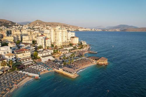 an aerial view of a beach with buildings and the water at Sunset Aparthotel in Sarandë