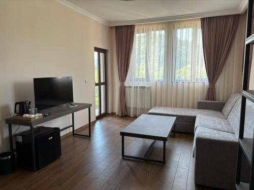 a living room with a couch and a table at Villa Irina - Veliko Tarnovo in Veliko Tŭrnovo