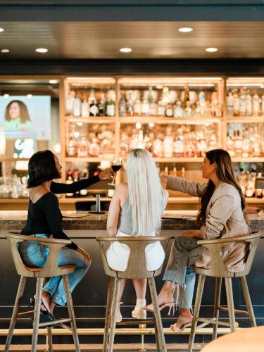 a group of women sitting at a bar at The Junto Hotel in Columbus