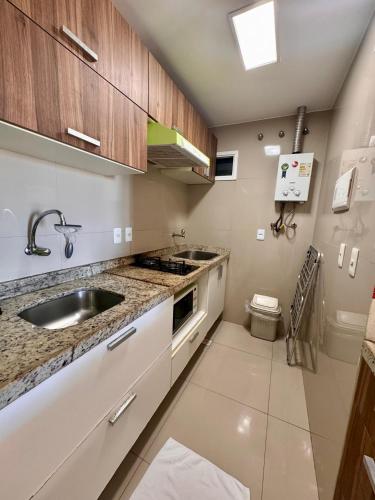 a kitchen with a sink and a counter top at VG FUN Praia do Futuro Pé na Areia ap 311 IMOB TEMPORADA in Fortaleza