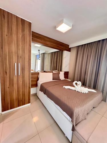a bedroom with a bed with a white ribbon on it at VG FUN Praia do Futuro Pé na Areia ap 311 IMOB TEMPORADA in Fortaleza