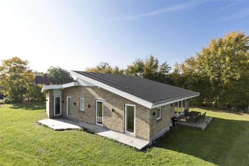 a small house on a grassy field with trees at N279-Karrebaeksminde-Eno-Kystvej-131 in Enø By