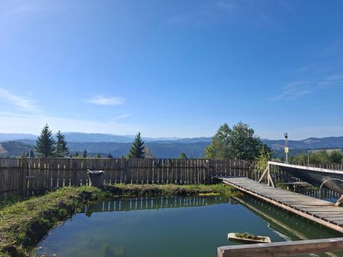 a pool of water in a yard with a wooden fence at Altan's Gold in Hangul