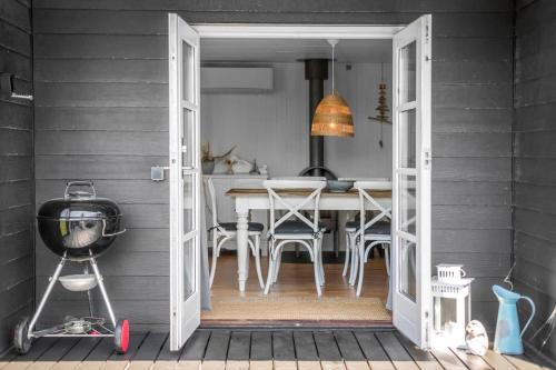 a kitchen and dining room with a table and a door at N319-Karrebaeksminde-Klintegardsvej-104 in Enø By
