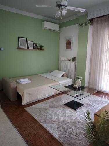 a bedroom with a bed and a glass table at Cozy apartment in the city center in Katerini