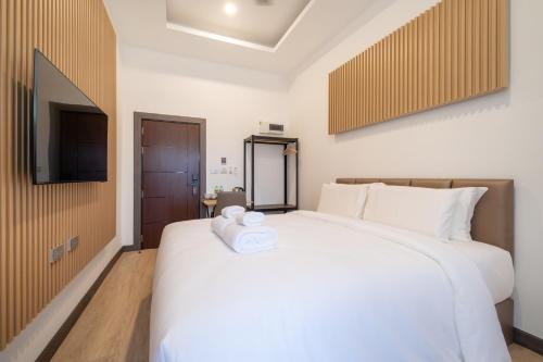 Ένα ή περισσότερα κρεβάτια σε δωμάτιο στο DC Resident Phuket