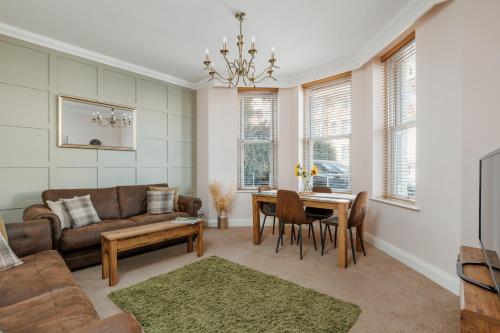 a living room with a couch and a table at Ocean Spray Suite by Grandeur Property in Bournemouth