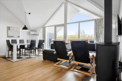a living room with a fireplace and a table and chairs at N102-Karrebaeksminde-Krageholmsvej-82 in Enø By