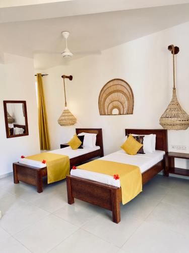 a room with two beds and a mirror at Olzadia Boutique Hotel in Michamvi