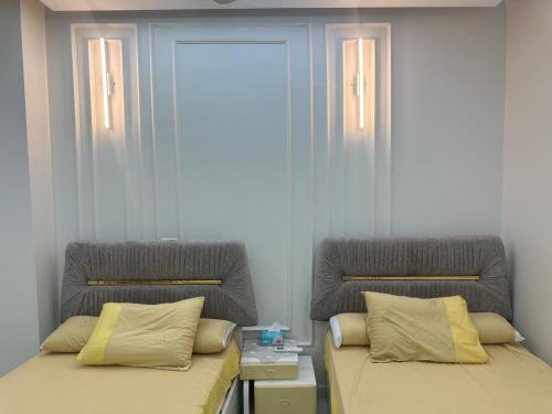 two beds sitting next to each other in a room at Eshyan Guest House in Aswan