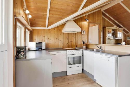 a kitchen with white appliances and a wooden ceiling at N090-Karrebaeksminde-Krageholmsvej-72 in Enø By