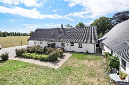 an exterior view of a white house with a yard at N159-Karrebaeksminde-Kirkebakken-40-B in Karrebæksminde