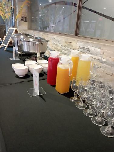 a table with wine glasses and a bunch of juice at Hotel Nicolás Temuco in Temuco