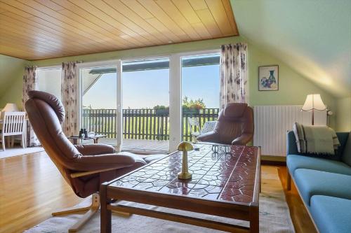 a living room with a couch and chairs and a table at N332-Karrebaeksminde-Ronhave-Parkvej-88 in Karrebæksminde
