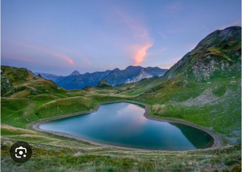 a lake in the middle of a mountain at les chalets de Maryline in Accous