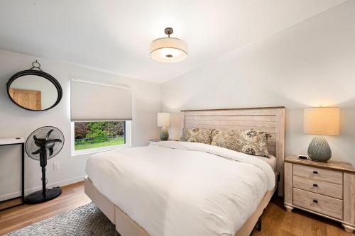 a bedroom with a large bed and a window at New Baileys Harbor Home, 1 block DT with Huge Yard in Baileys Harbor