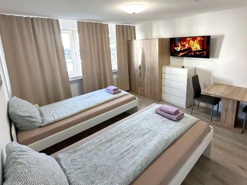 a bedroom with two beds and a fireplace at Beautiful apartment in Bergkamen bei Dortmund in Bergkamen