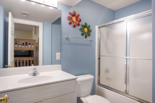 a bathroom with a toilet and a sink and a shower at 3054 - Latitude Adjustment in Southern Shores
