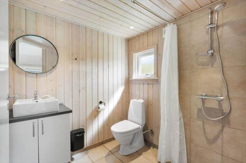 a bathroom with a toilet and a sink and a shower at JB232-Brovst-Kronvildtvej-20 in Tranum