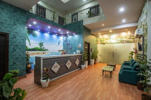 a living room with a fireplace and a blue couch at Hotel Paradise Park At Airport in New Delhi
