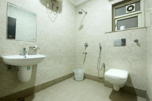 a bathroom with a sink and a toilet and a shower at Hotel Paradise Park At Airport in New Delhi