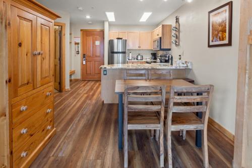 a kitchen with wooden floors and a wooden table and chairs at River Run Village by Keystone Resort in Keystone