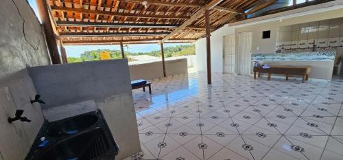 a large room with a tile floor and a fireplace at Pousada Mar de Itacaré in Itacaré