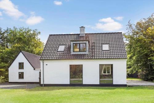 a white house with a black roof at JB1031-Fjerritslev-Thorup-Strandvej-266 in Torup Strand