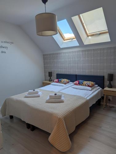 a bedroom with two beds with towels on them at Apartament Przy Potoku in Zubrzyca Górna