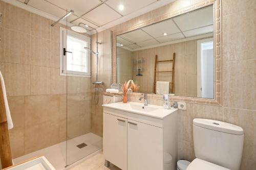 a bathroom with a toilet and a sink and a shower at Casa BuenaVista Calpe in Casas de Torrat