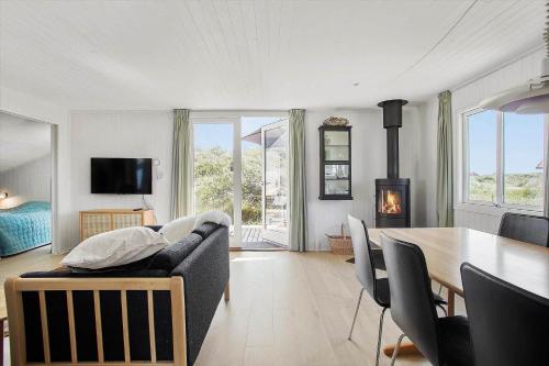 a living room with a couch and a table at JB183-Frostrup-Svenstibakkevej-70 in Lild Strand
