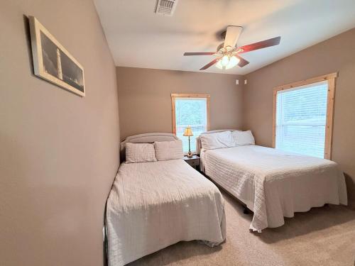 a bedroom with two beds and a ceiling fan at Carlene's Place in Kingston