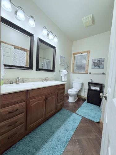 a bathroom with a sink and a toilet and a mirror at Carlene's Place in Kingston