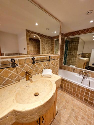 a large bathroom with a sink and a tub at Apartment in Bargemon in Bargemon